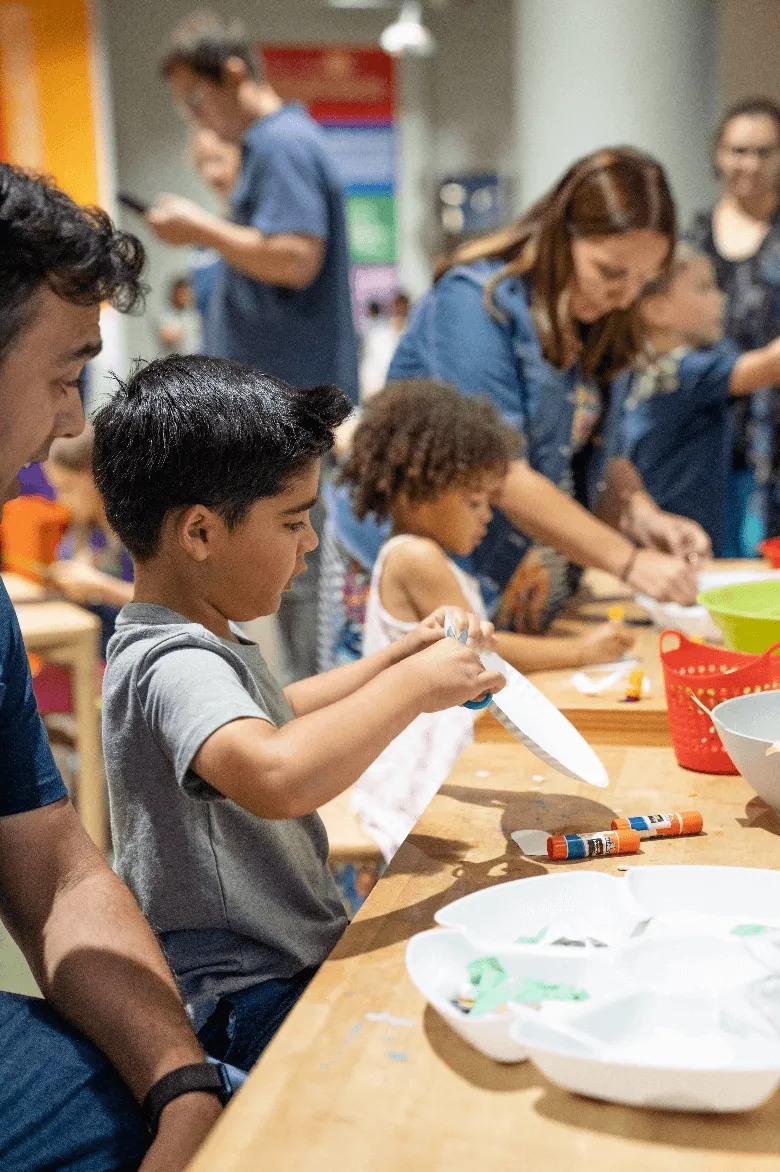Young boy making a craft at the Children's Museum of the Upstate Greenville location.