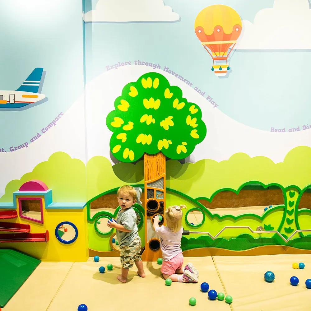 Kids playing at the Palmetto Basics Toddler Zone exhibt in the Children's Museum of the Upstate Spartanburg location.