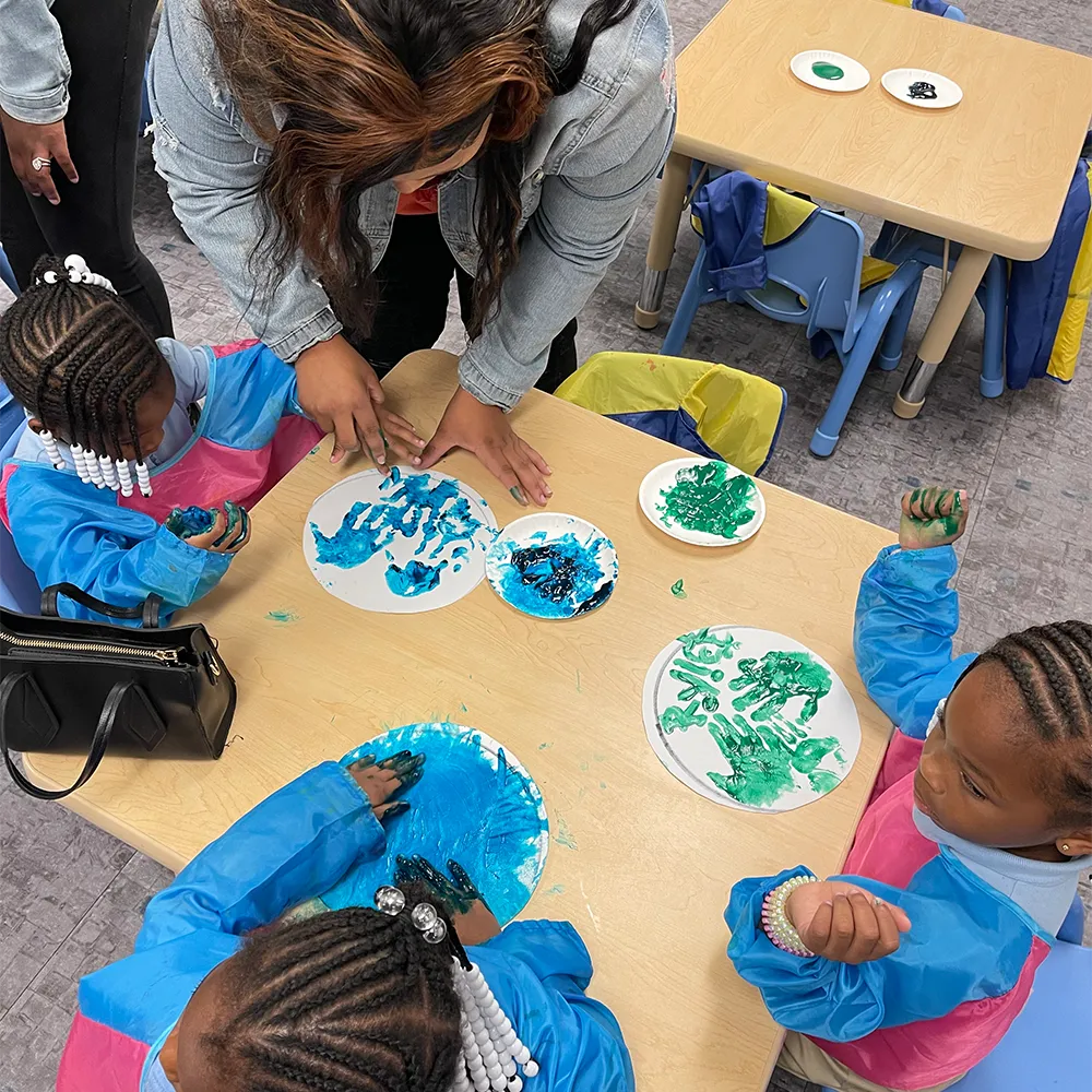 Parent and kids making art at the open art studios at the Children's Museum of the Upstate Spartanburg location.