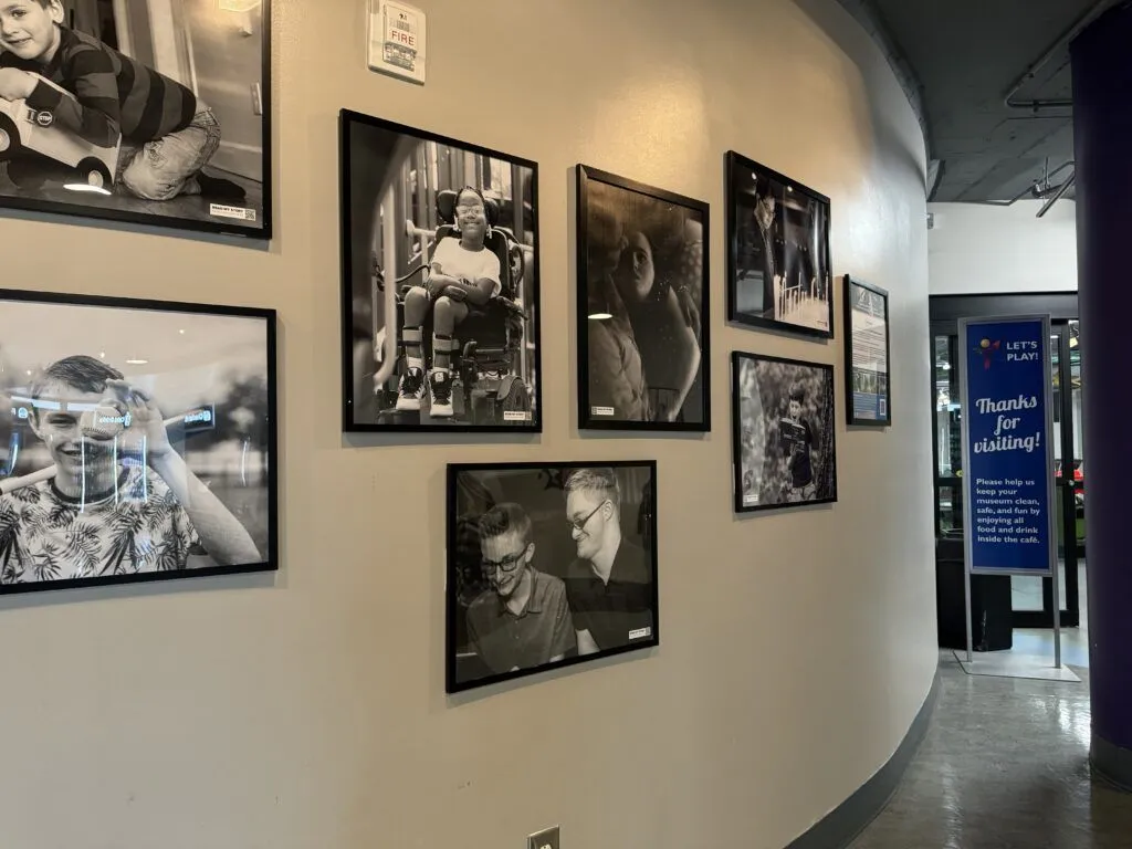 a wall with many pictures hanging on it