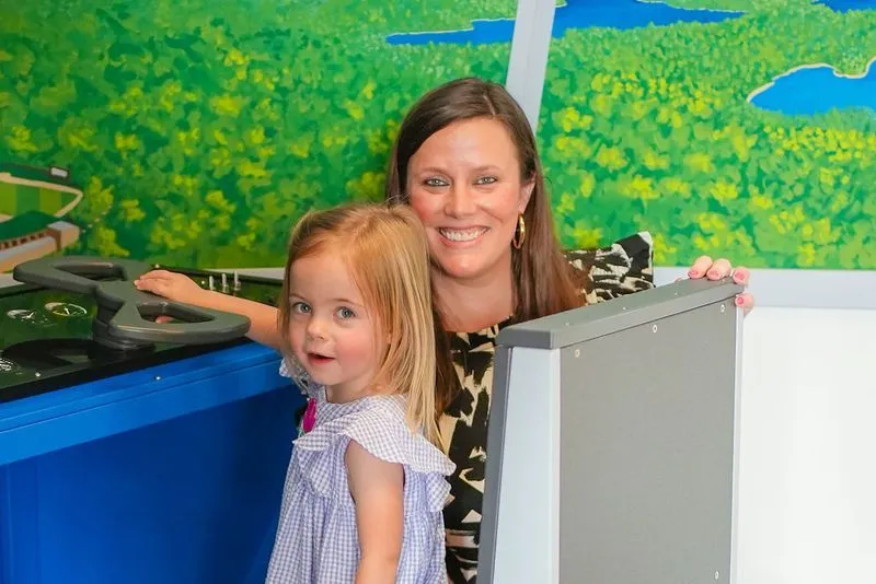 a woman and a little girl standing next to each other