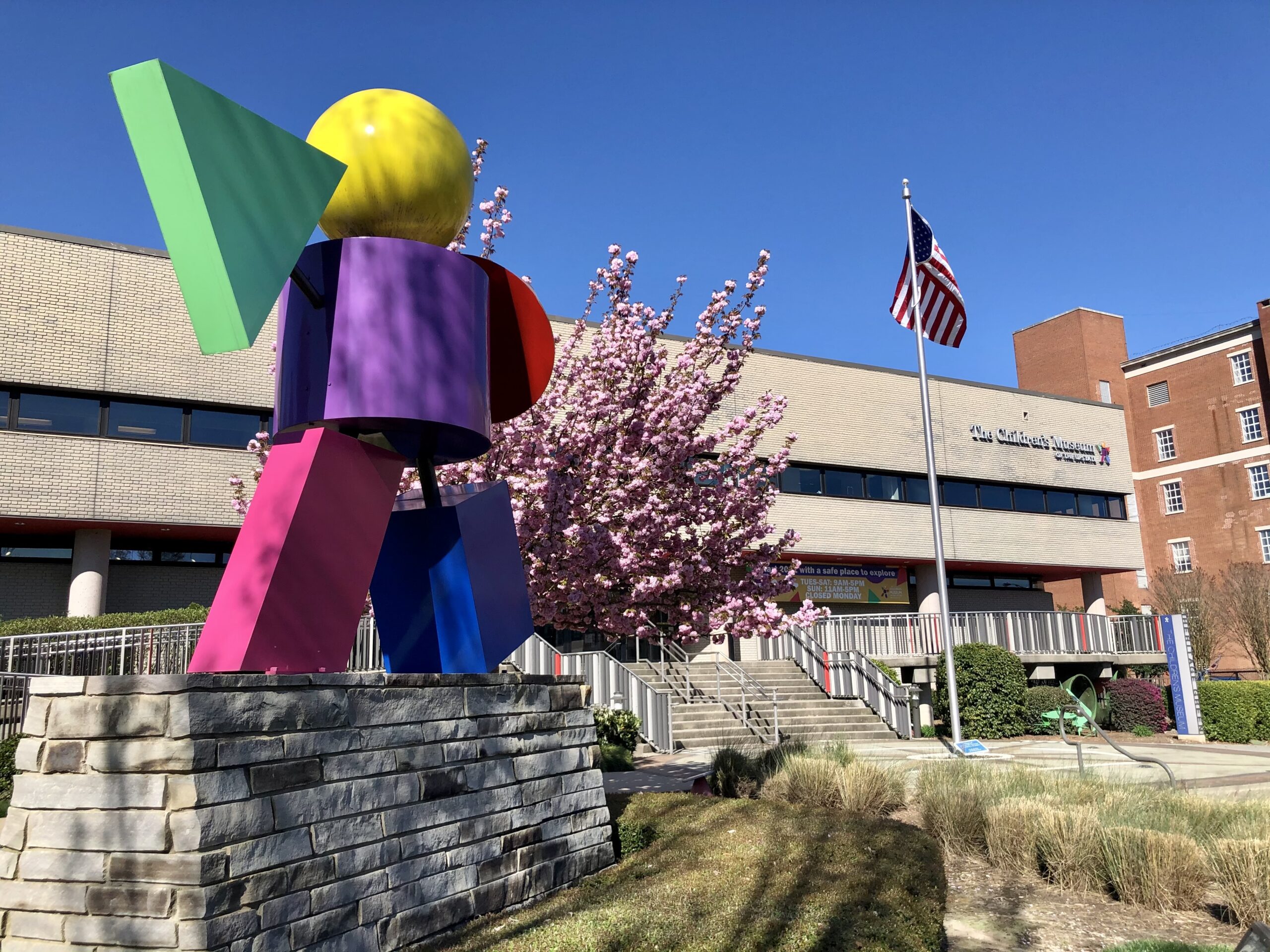 a sculpture of a person in front of a building