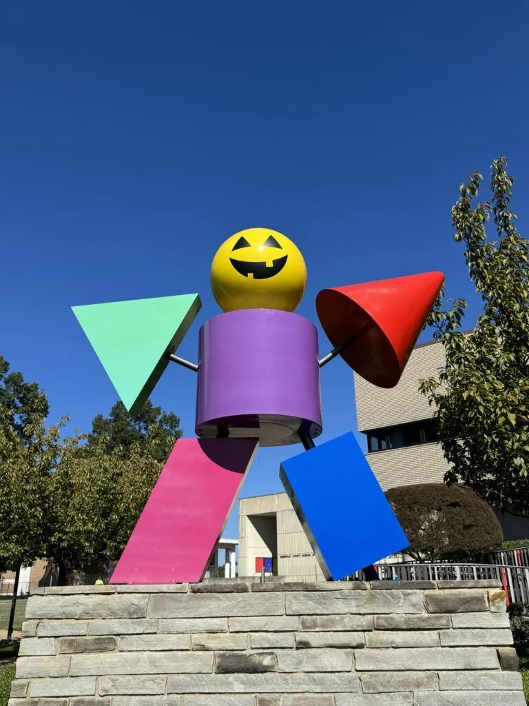 a brightly colored windmill with a smiley face on it