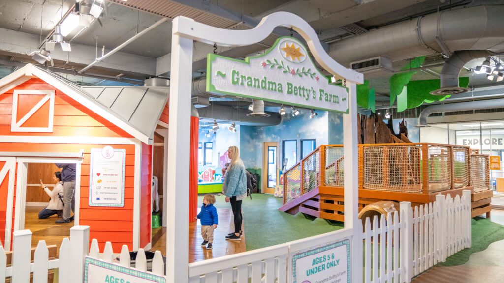 a children's play area with a wooden play structure