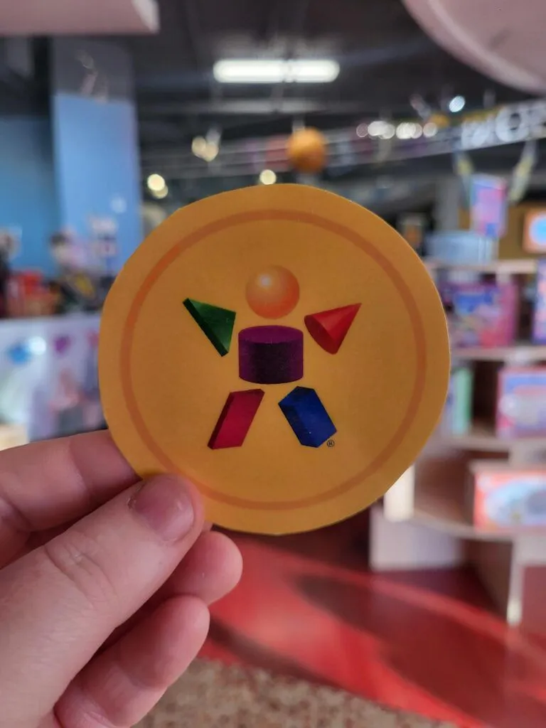 a person holding a yellow frisbee with a picture of a person on it