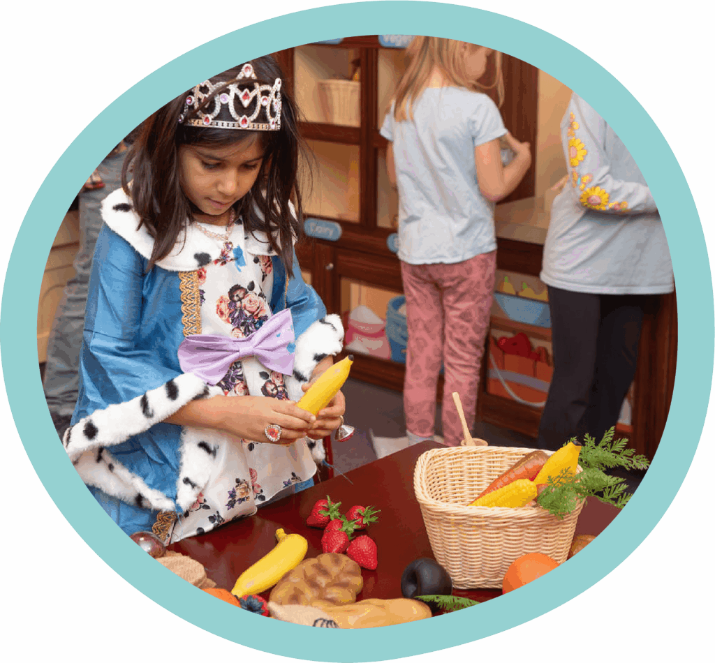 Girl dressed in princess costume playing at the Publix exhibit at the Children's Museum of the Upstate Spartanburg location.