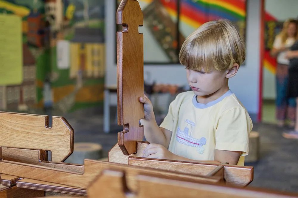 Child playing with wooden building blocks