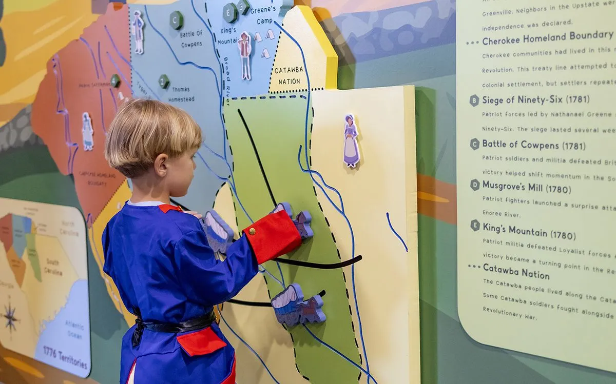 child playing with a map of South Carolina
