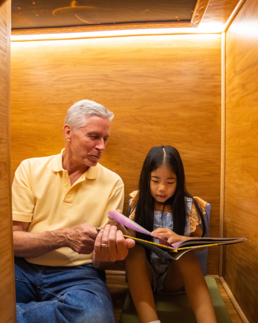 father reads to daughter